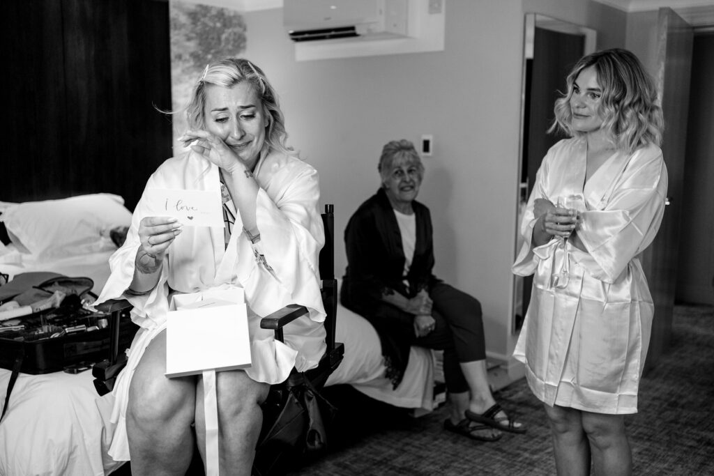 Bride in happy tears from Grooms present at Ellie and Sam's Rhinefield House Hotel wedding in the New Forest