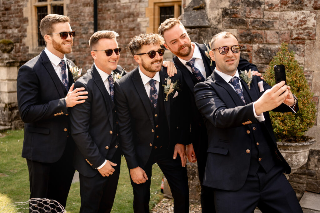 Groomsmen taking selfie at Ellie and Sam's Rhinefield House Hotel wedding in the New Forest