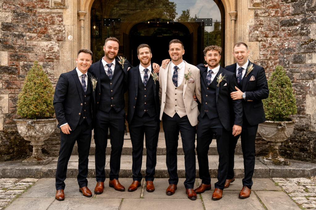 Groomsmen photo at front of Rhinefield House