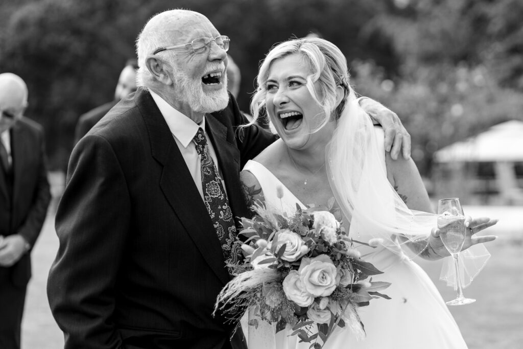 Bride laughing with Grandad at Rhinefield House Hotel wedding
