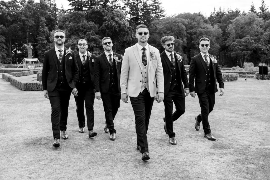 Groomsmen walking with shades on