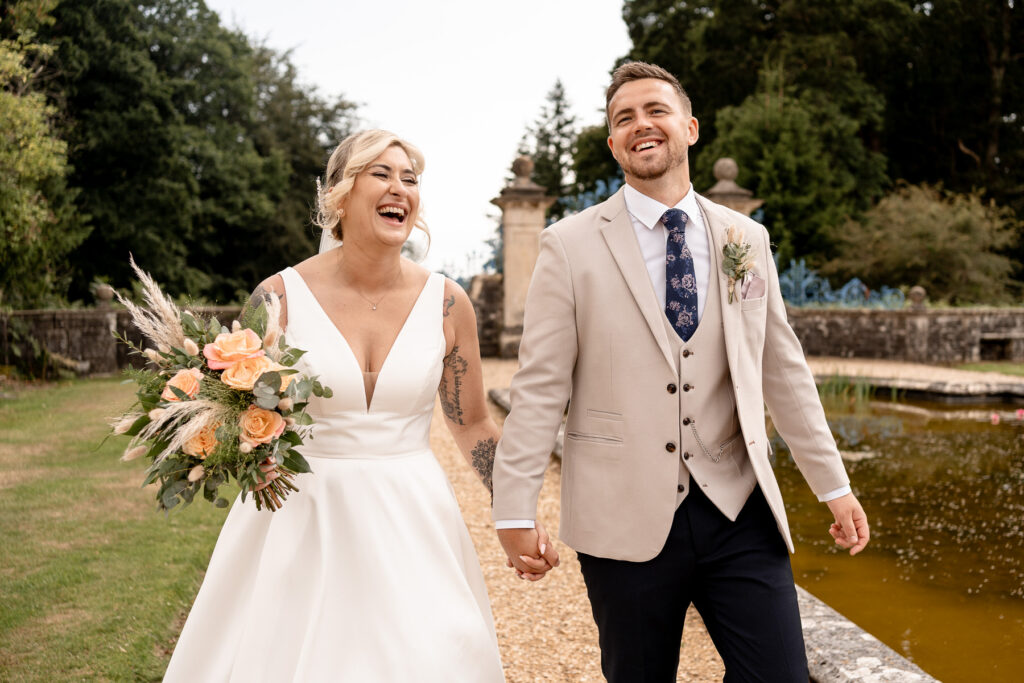 Rhinefield House Hotel Wedding photographer for Ellie and Sam - Bride and Groom laughing