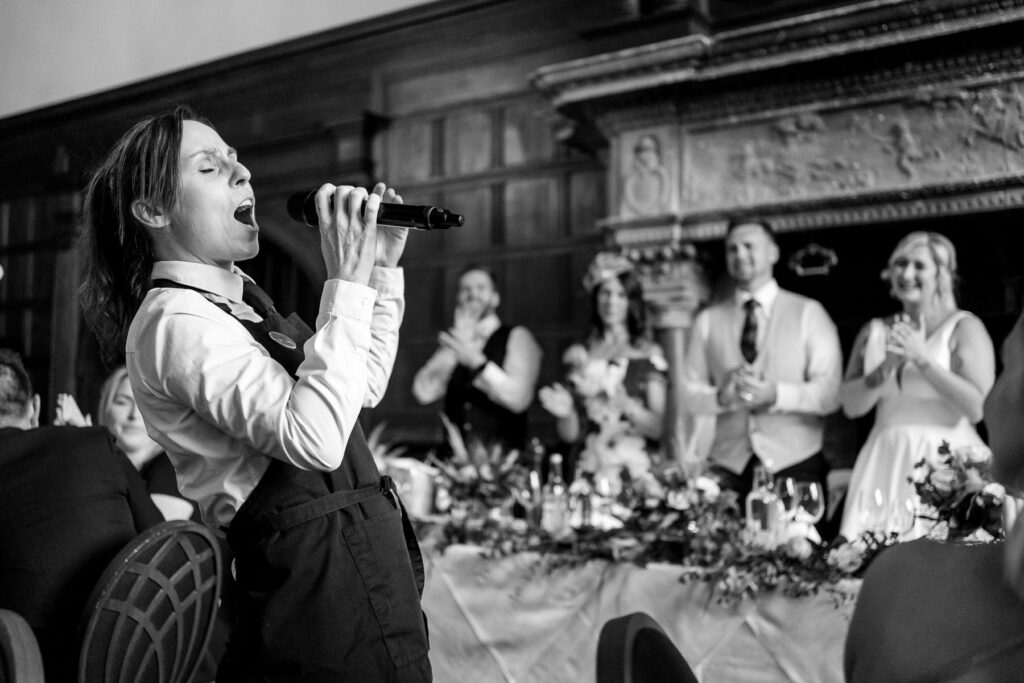 Rhinefield House Hotel Wedding photographer for Ellie and Sam - Surprise singing waitors