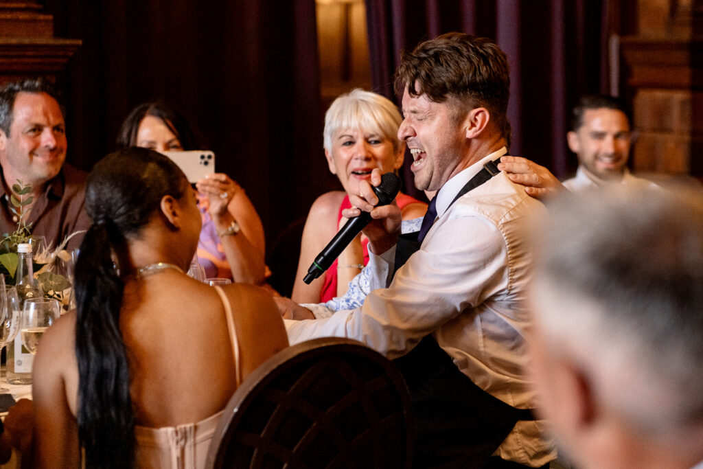 Rhinefield House Hotel Wedding photographer for Ellie and Sam - surprise singing waitors