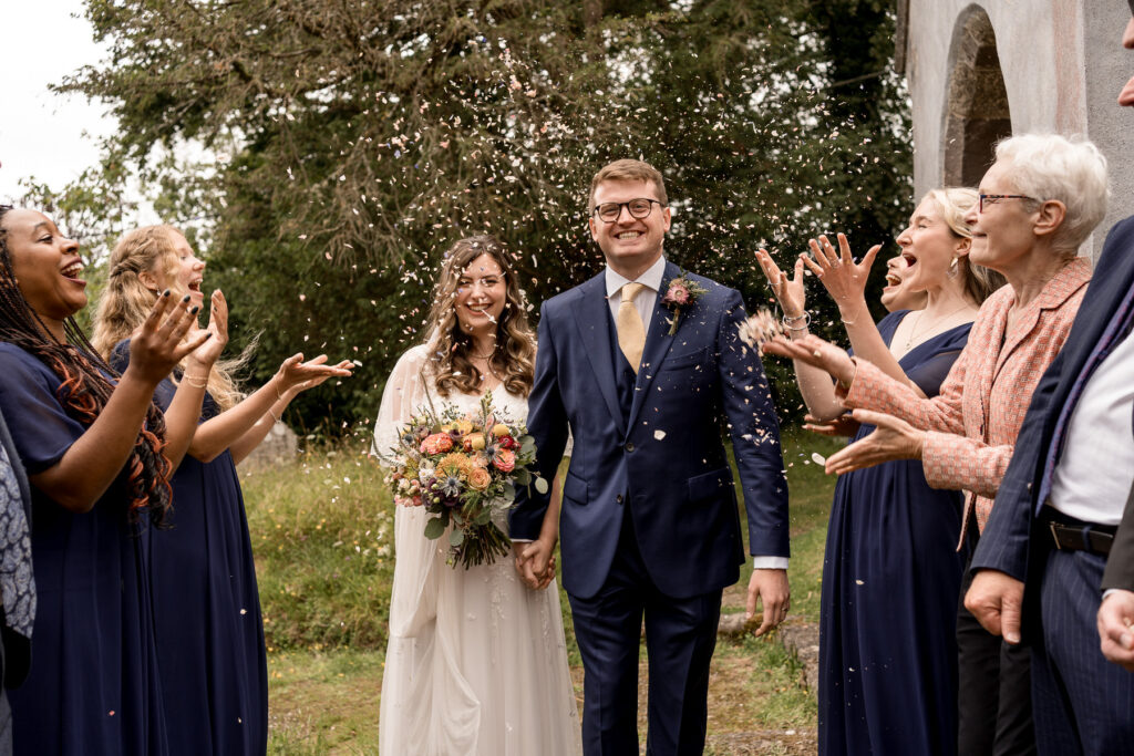 Bride and groom outside The Great Barn Devon after church ceremony