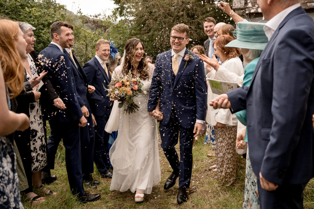 Bride and groom outside The Great Barn Devon after church ceremony