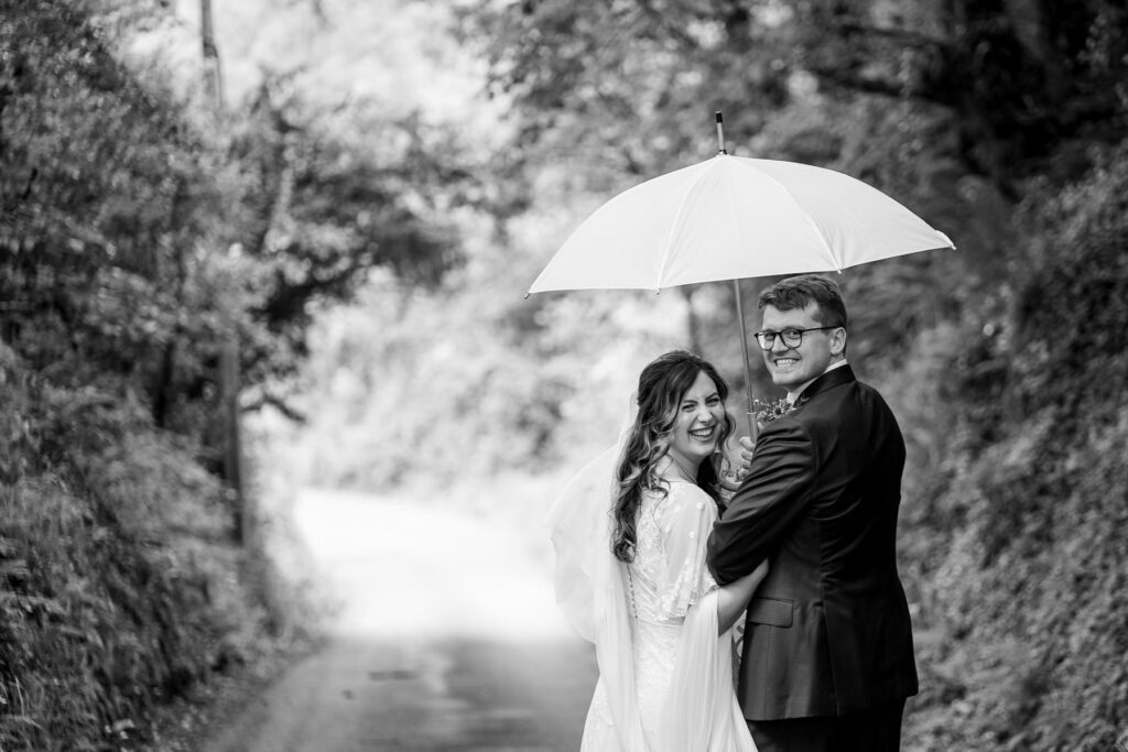 Bride and groom outside The Great Barn Devon after church ceremony