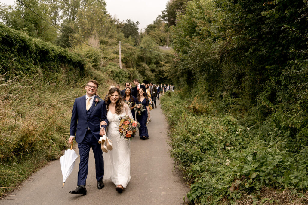 Bride and groom outside The Great Barn Devon after church ceremony