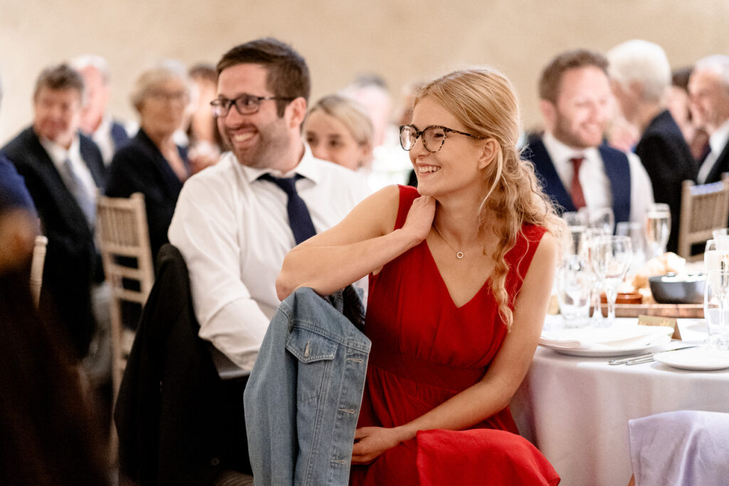 Guests laughing during speeches at The Great Barn Devon