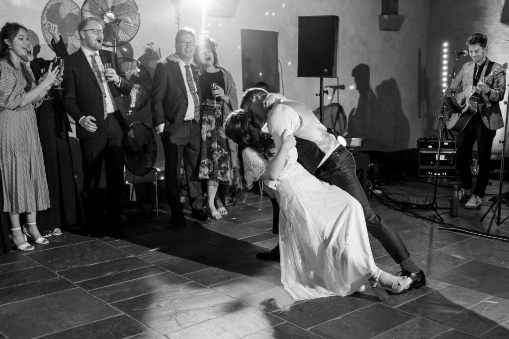 Bride and groom first dance inside The Great Barn Devon
