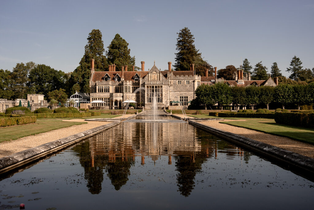 The stunning exterior of Rhinefield House Hotel surrounded by forest, one of Hampshire’s most beautiful wedding venues.
