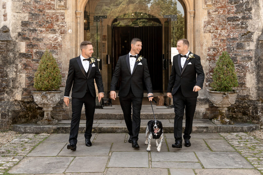 The couple’s spaniel wearing a bow tie as the groom’s dog at Rhinefield House wedding