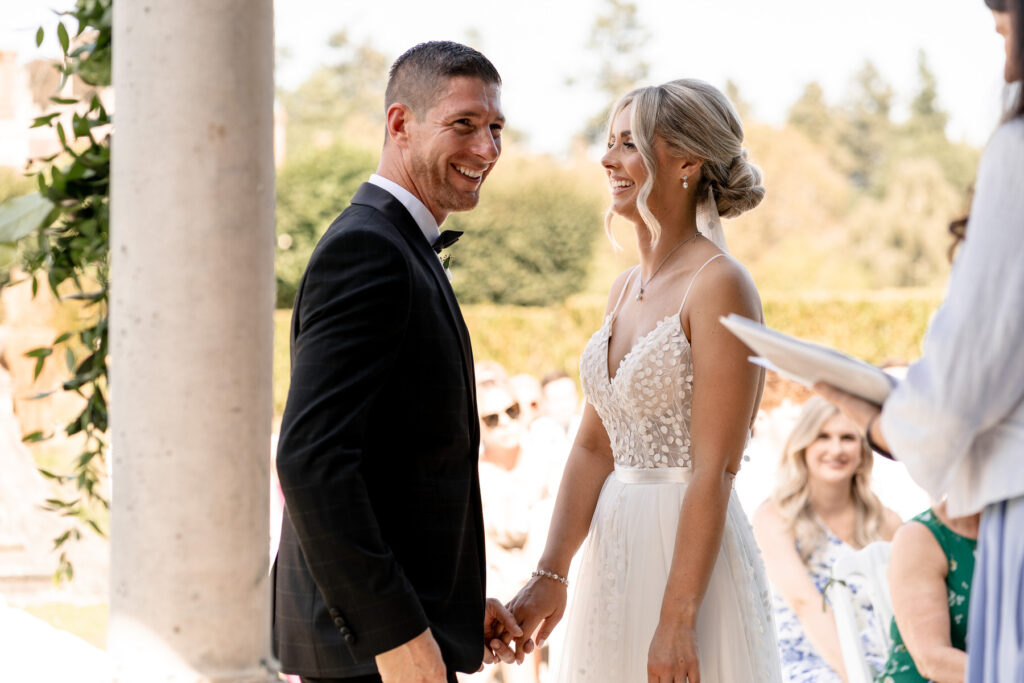 Bride and groom exchanging vows during their Rhinefield House wedding ceremony in the New Forest.