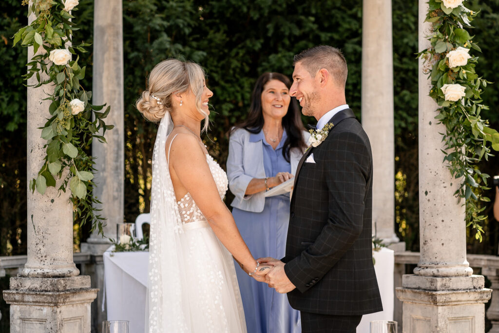 Bride and groom exchanging vows during their Rhinefield House wedding ceremony in the New Forest.