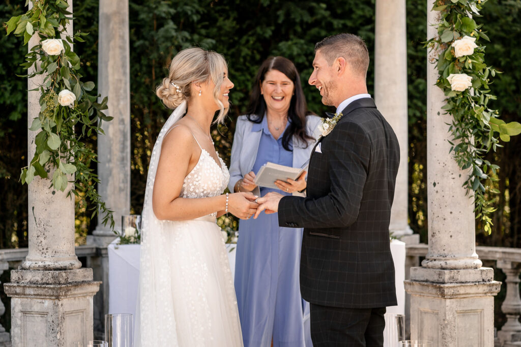 Bride and groom exchanging vows during their Rhinefield House wedding ceremony in the New Forest.