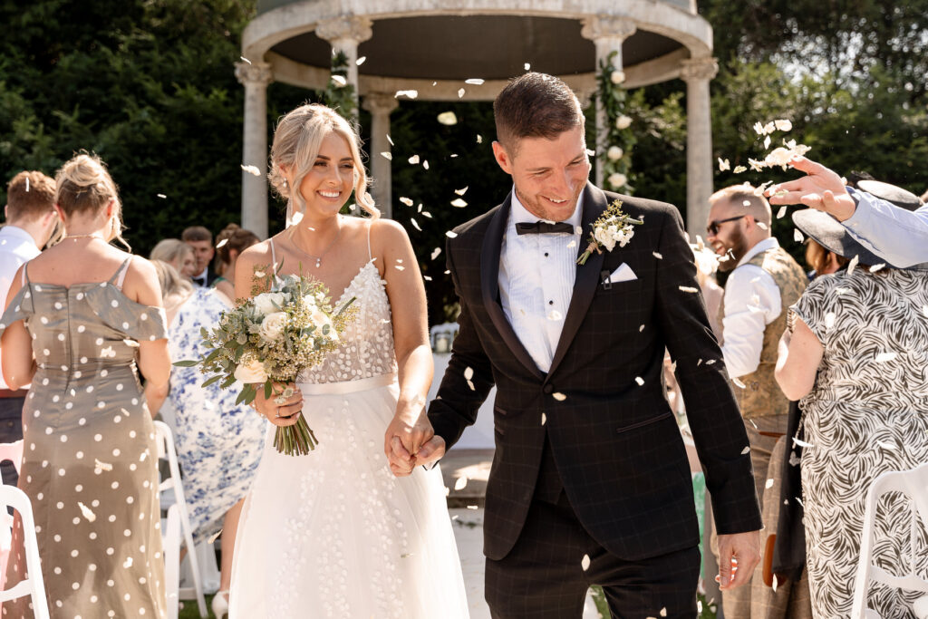 Bride and groom exchanging vows during their Rhinefield House wedding ceremony in the New Forest.