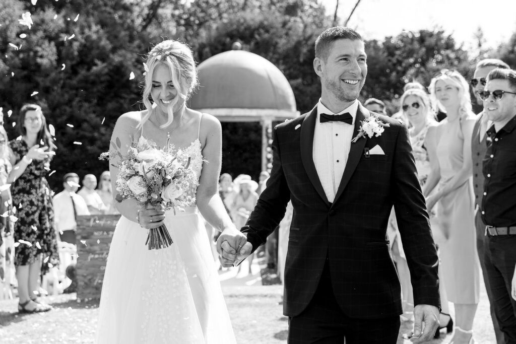 Bride and groom exchanging vows during their Rhinefield House wedding ceremony in the New Forest.