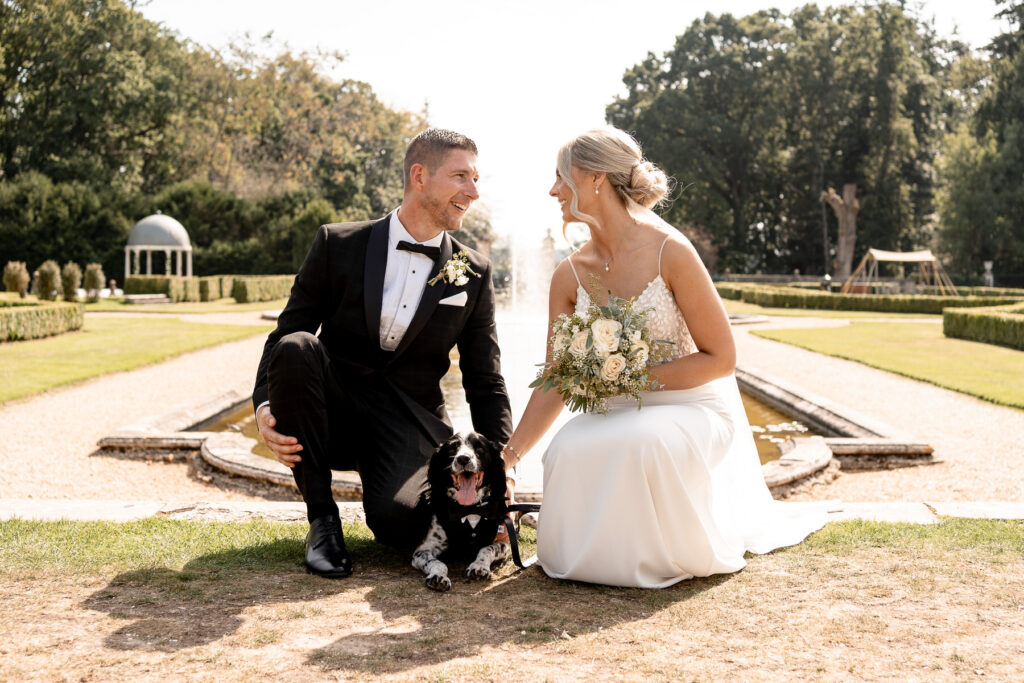 The couple’s spaniel wearing a bow tie as the groom’s dog at Rhinefield House wedding