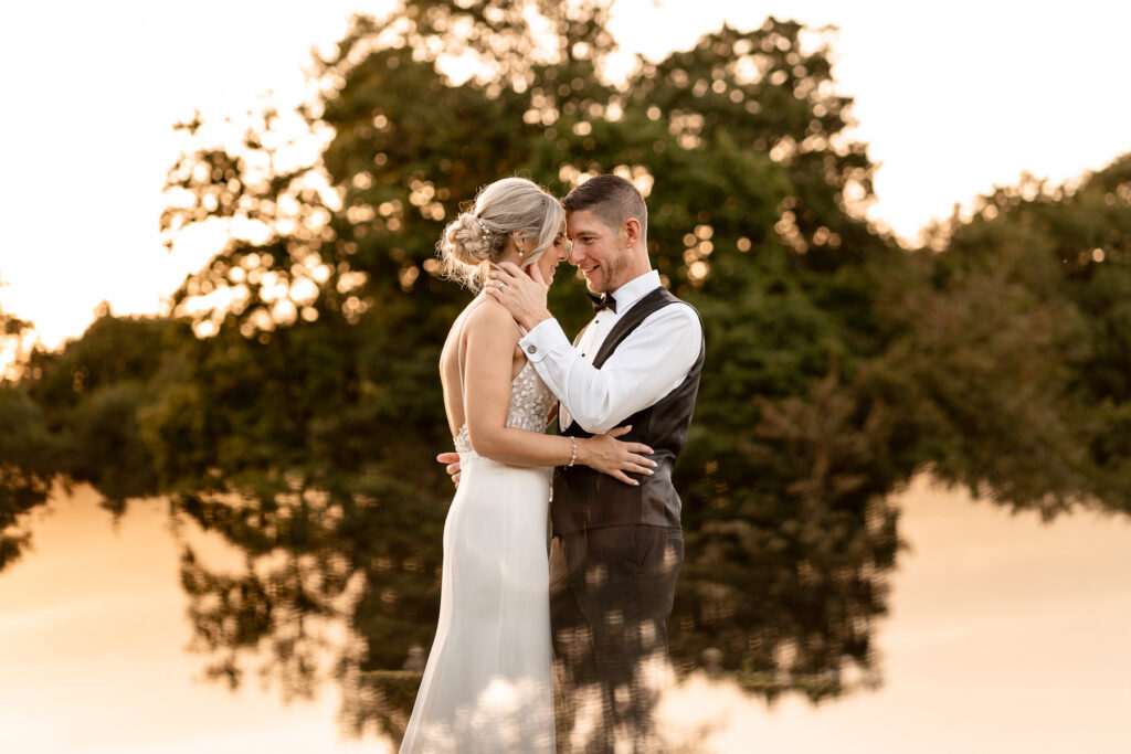 Bride and groom walking through the gardens at Rhinefield House during golden hour wedding photography.