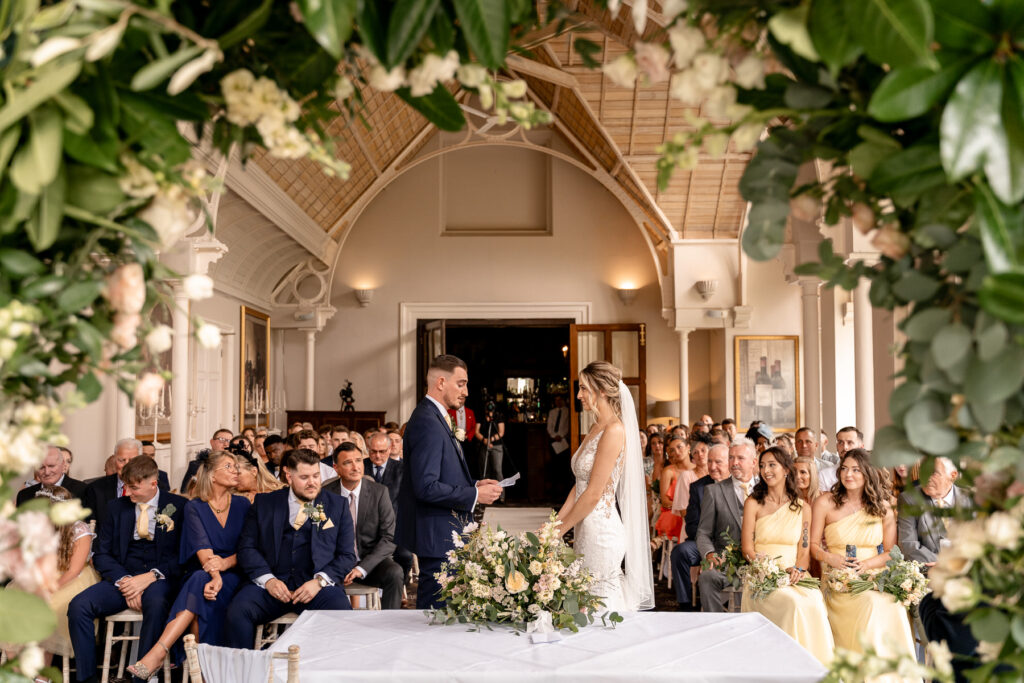 indoor wedding ceremony decor at a Summer wedding at Audleys Wood