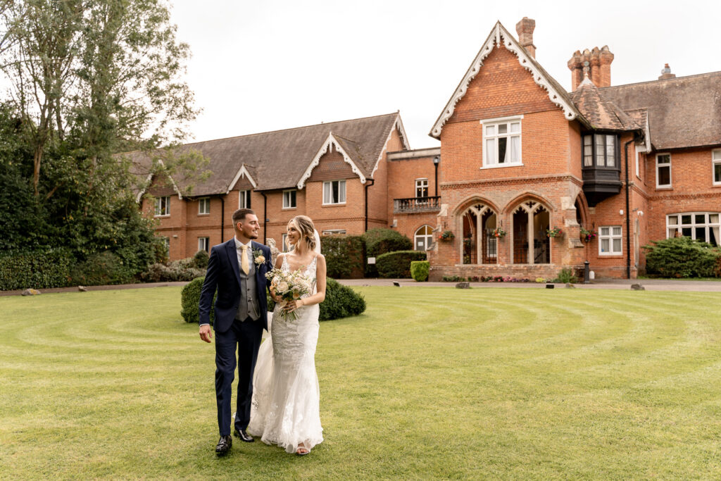 Bride and Groom walking at a Summer wedding at Audleys Wood