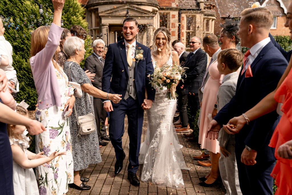 bubble line and confetti line with Bride and Groom at a Summer wedding at Audleys Wood