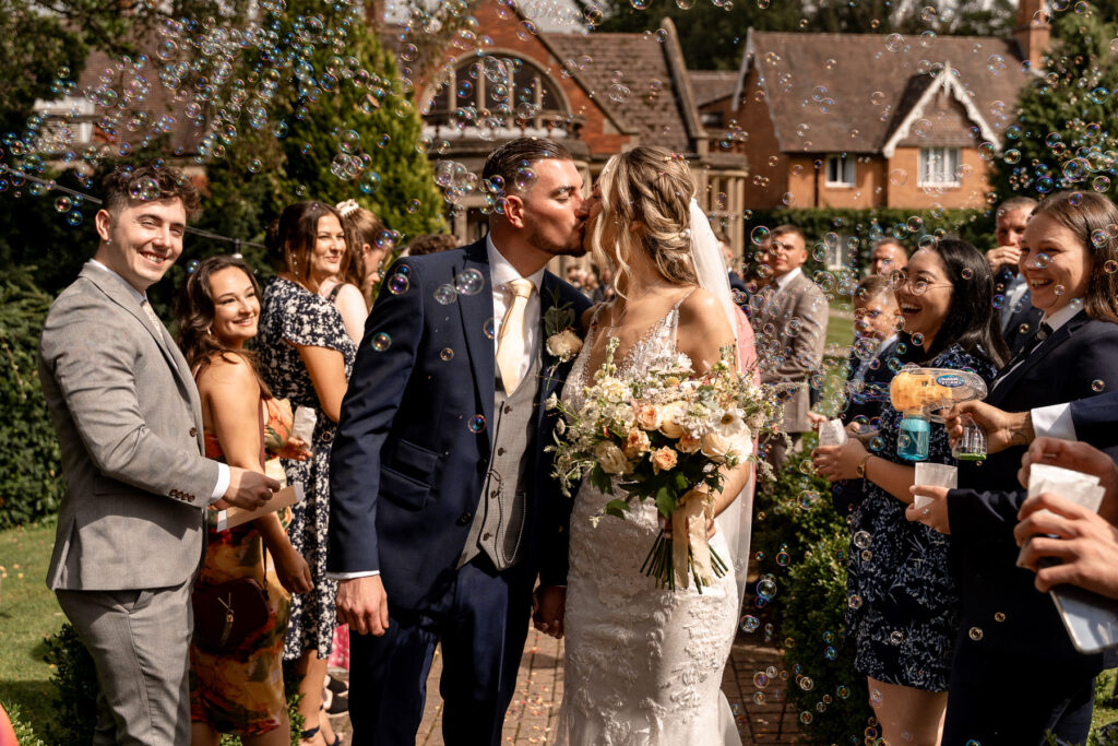 bubble line and confetti line with Bride and Groom at a Summer wedding at Audleys Wood
