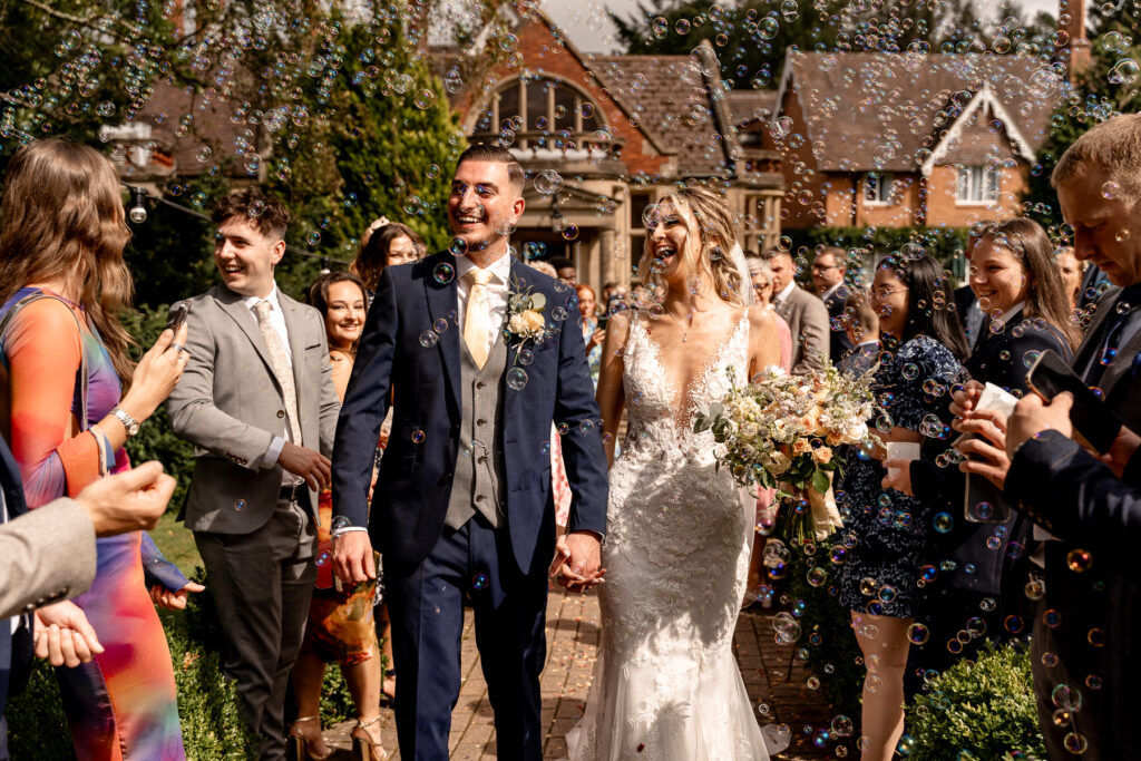 bubble line and confetti line with Bride and Groom at a Summer wedding at Audleys Wood