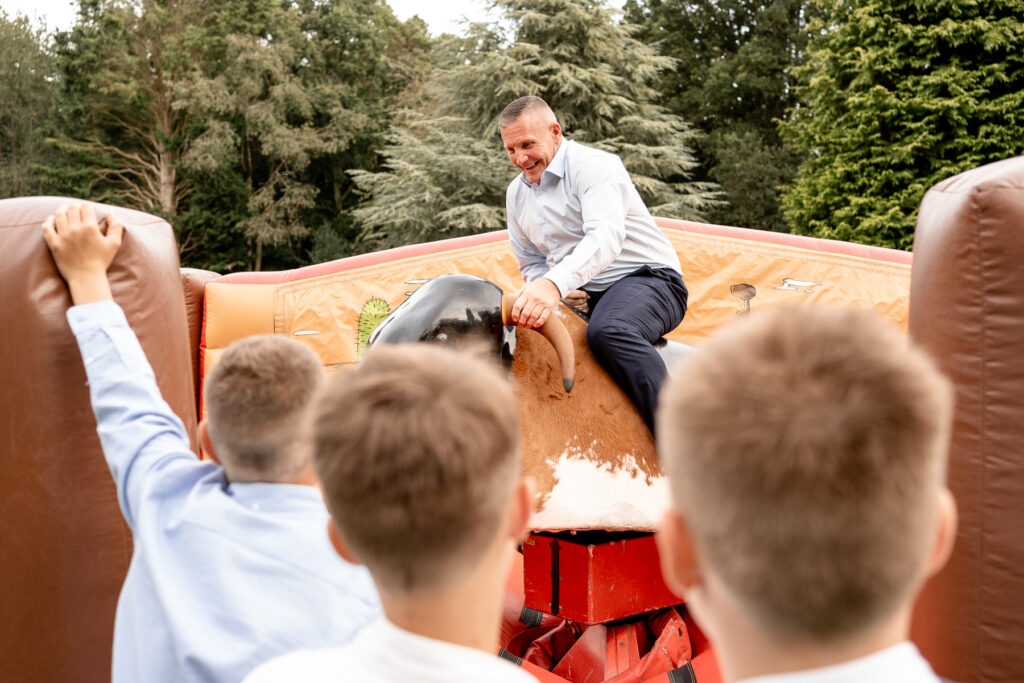 grandad on bucking bronco at a Summer wedding at Audleys Wood