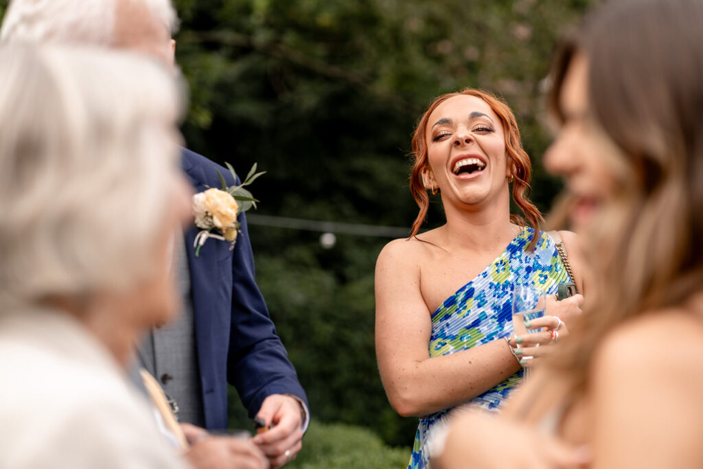 guest laughing at at a Summer wedding at Audleys Wood