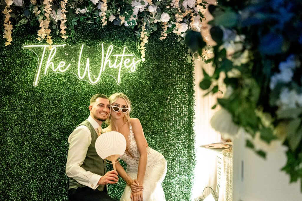 Bride and Groom in photobooth at a Summer wedding at Audleys Wood